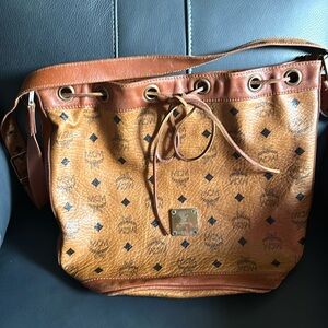 MCM drawstring handbag, has 1 inside zip pocket.